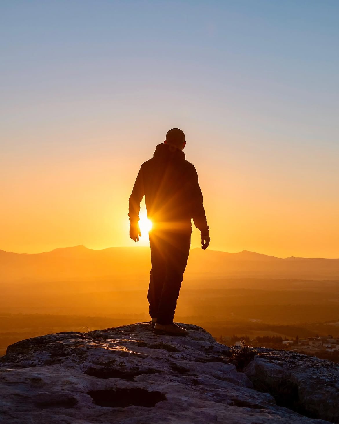 Silhouette on a ridge at sunset