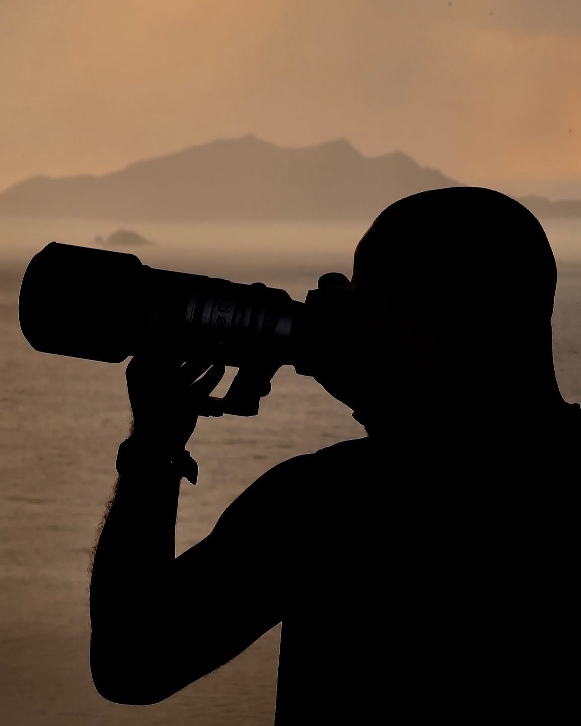 Silhouette of a photographer holding a camera