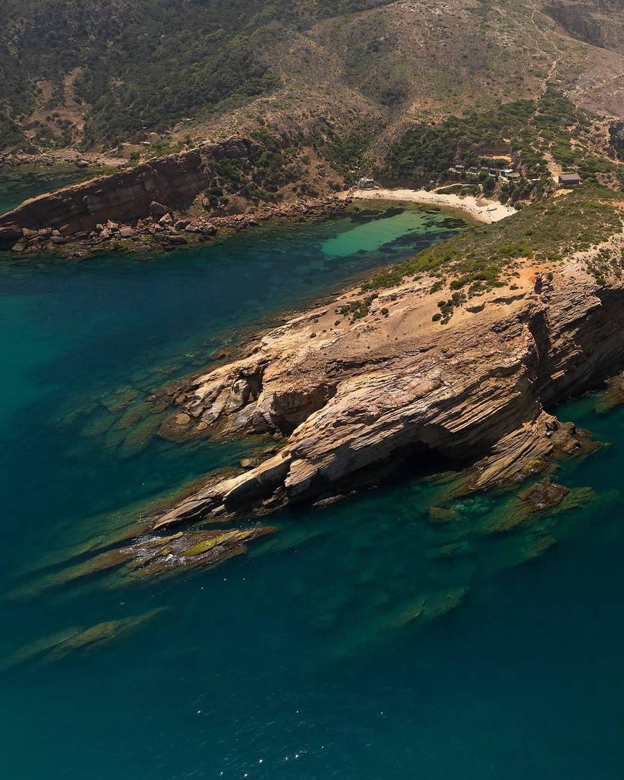 Rocky coastline and clear turquoise water seen from above