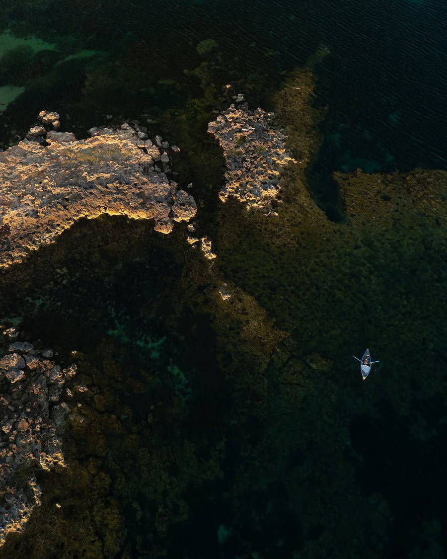 Kayak seen from above in dark blue water