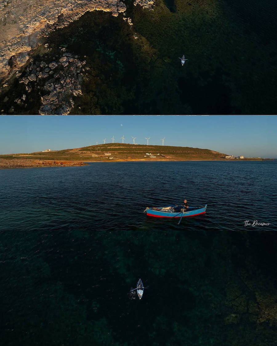 Small boat on the boundary between dark and shallow water