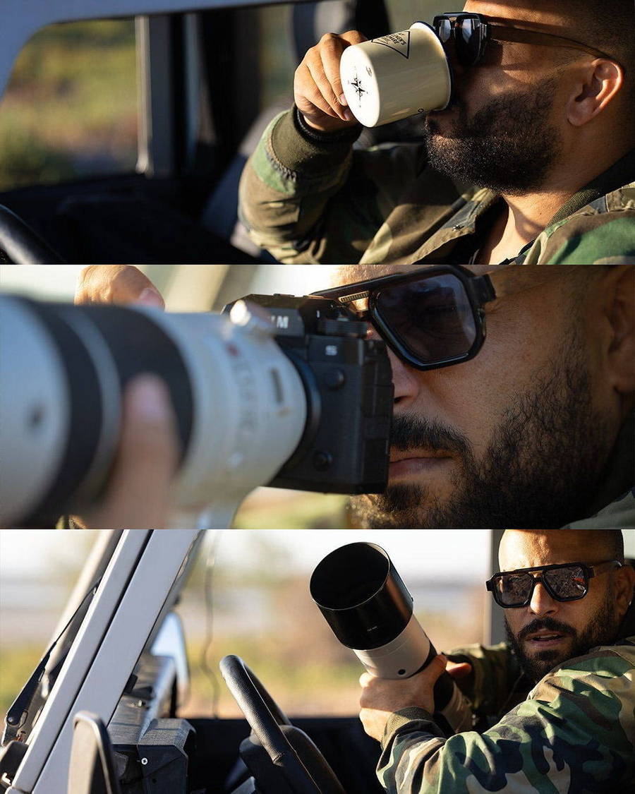 Wildlife photographer using binoculars and camera in the field
